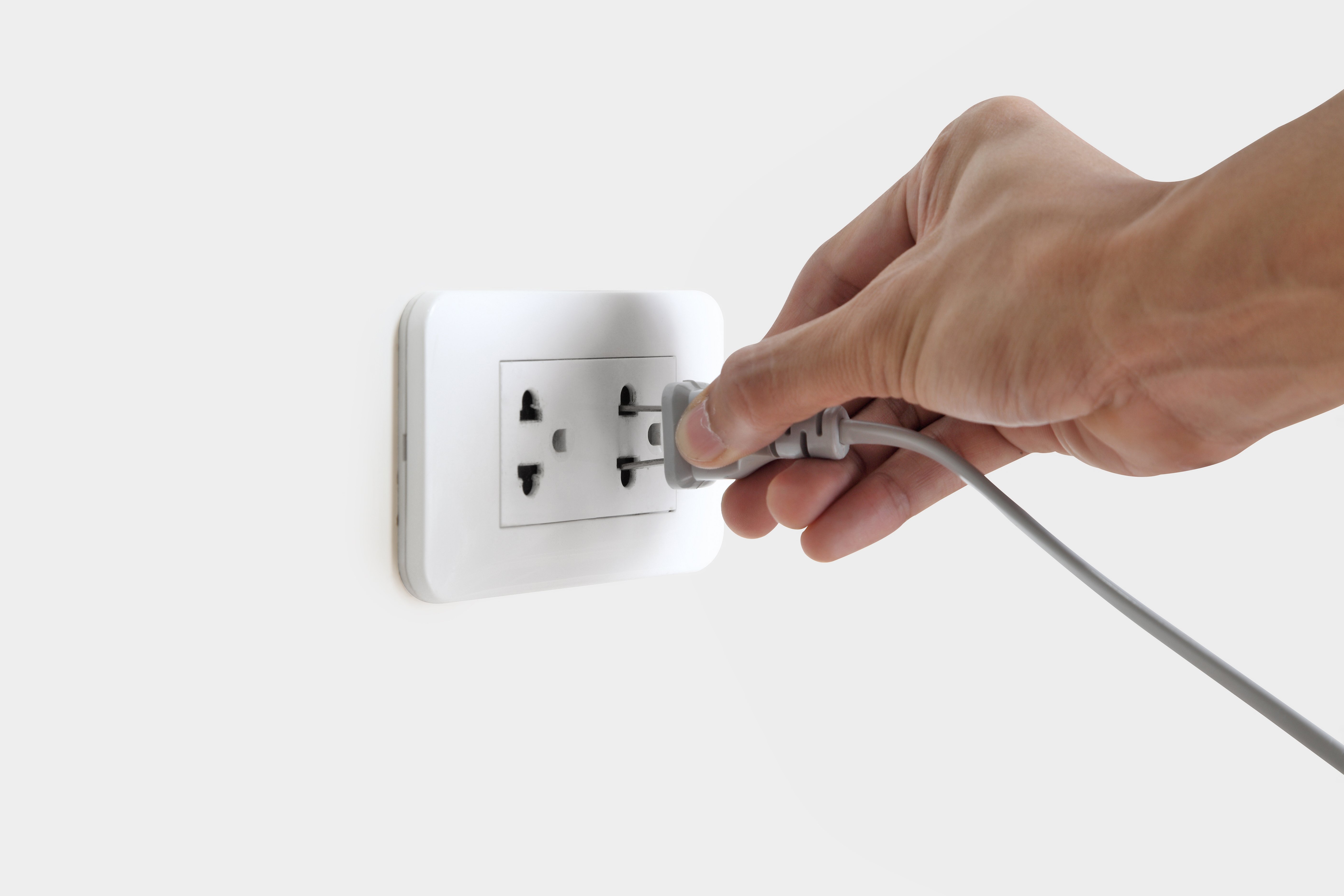 vecteezy_hand-plugging-in-electric-cord-to-a-white-socket_3125118