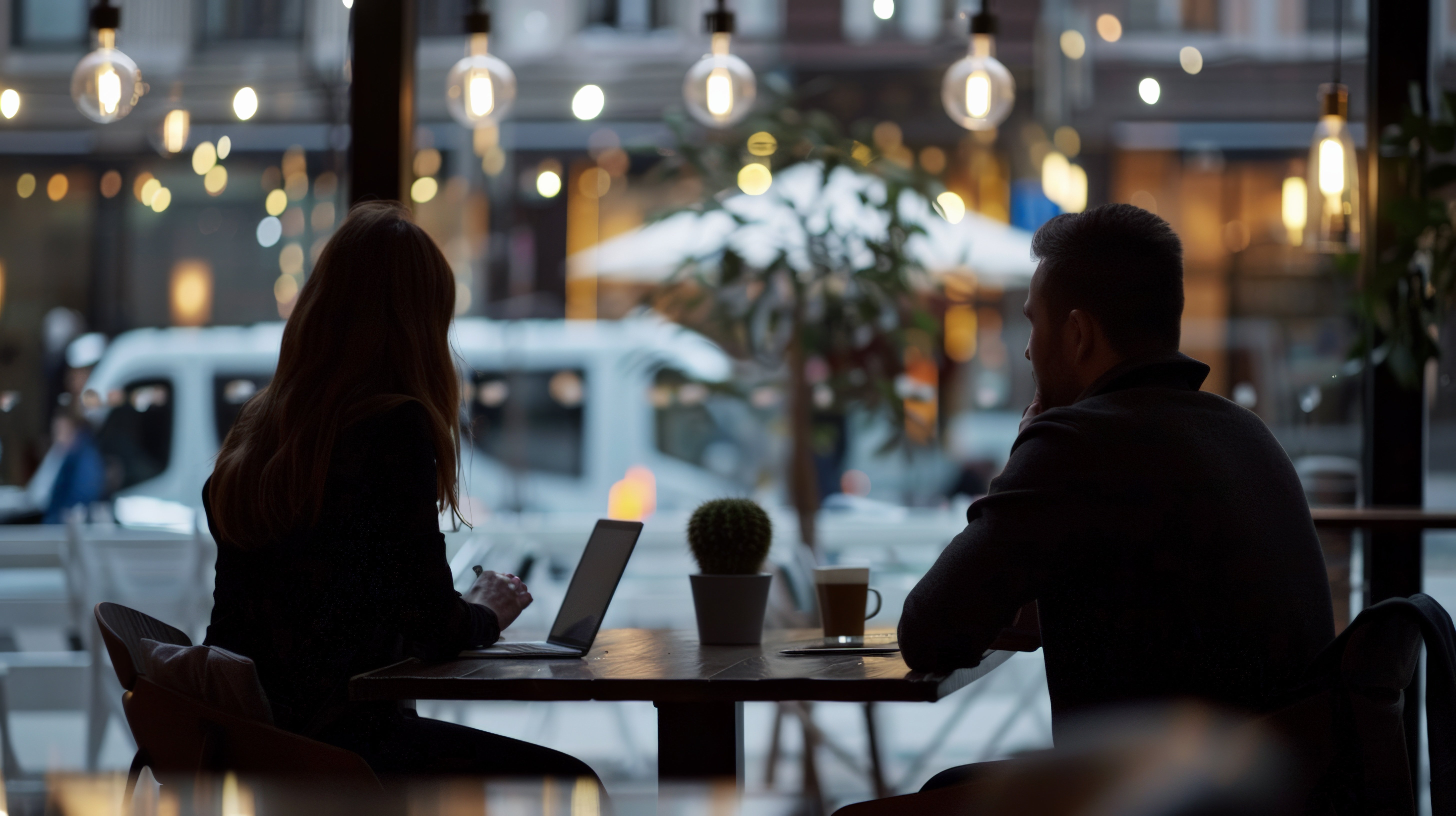 vecteezy_silhouettes-of-two-people-sitting-at-a-cafe-table-with_47352699